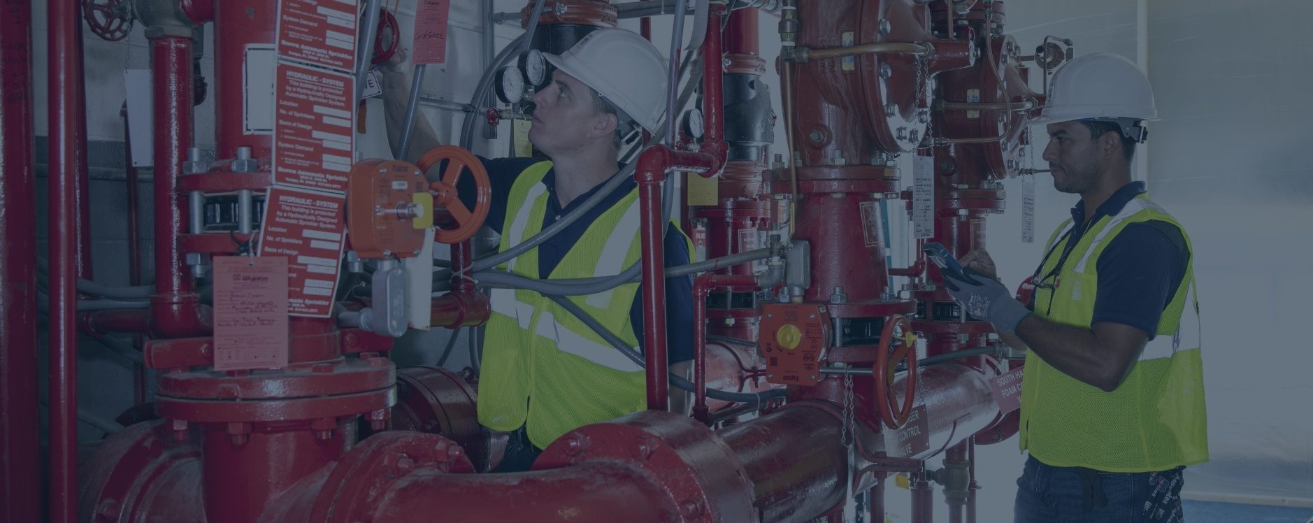 Wiginton technicians checking a bank of risers and valves